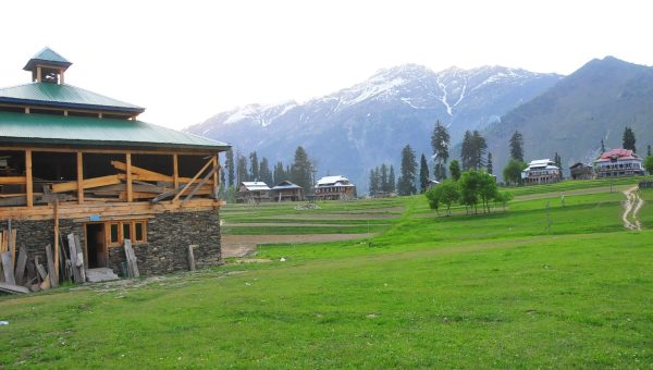 Arang Kel village in Neelam Valley, Azad Kashmir with green meadows, pine forests, and panoramic mountain views