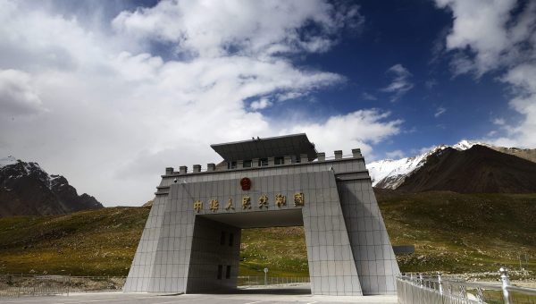 Snow-covered Khunjerab Pass with Karakoram Highway winding through high mountains