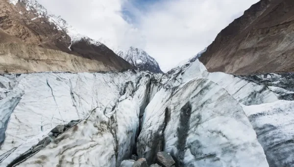Snow-capped peaks of the Karakoram mountain range under a clear blue sky