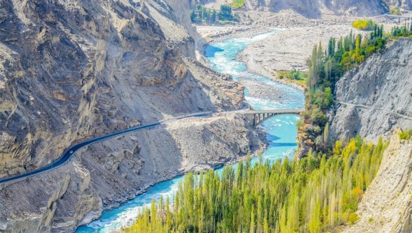 Crystal-clear turquoise waters of Attabad Lake surrounded by mountains in Hunza Valley