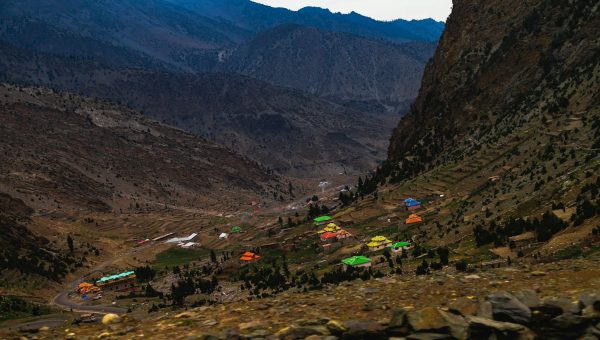 Panoramic view of Babusar Top mountain pass with winding roads and snow-capped peaks in Naran Kaghan Valley, Pakistan