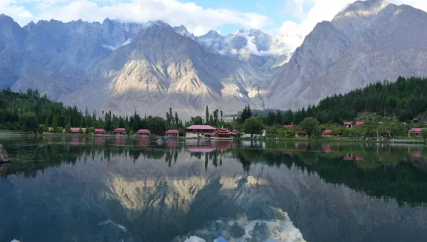 View of Shangrila Resort Skardu with crystal-clear lake, red-roof cottages, and surrounding mountains in Gilgit Baltistan, Pakistan